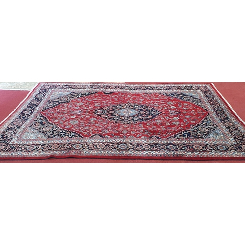 498 - A really good quality Red ground Persian Kashan Carpet with a traditional Kashan design with blue bo... 