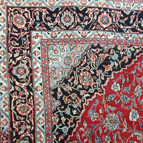 498 - A really good quality Red ground Persian Kashan Carpet with a traditional Kashan design with blue bo... 