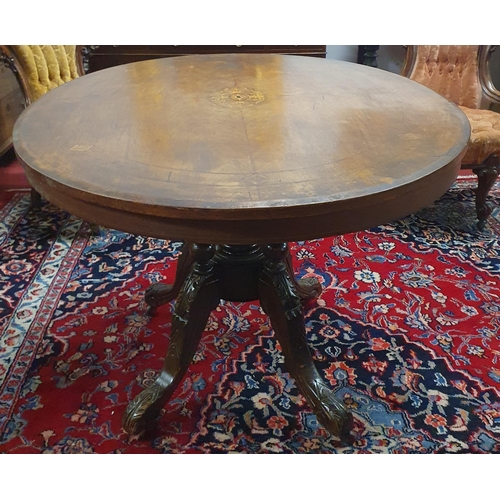 501 - A 19th Century oval Walnut and inlaid supper Table on quatrefoil base. 119 x 89 cm approx.