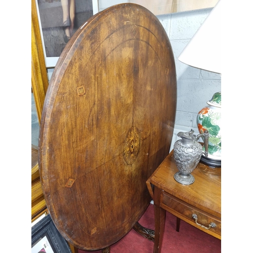 501 - A 19th Century oval Walnut and inlaid supper Table on quatrefoil base. 119 x 89 cm approx.