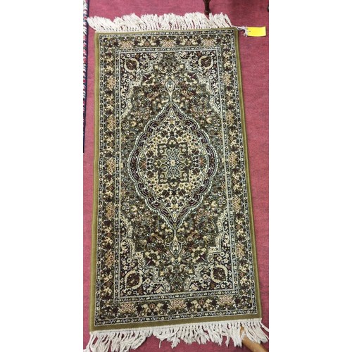 613 - A green ground Rug with multi borders and allover decoration. 150 x 69 cm approx.