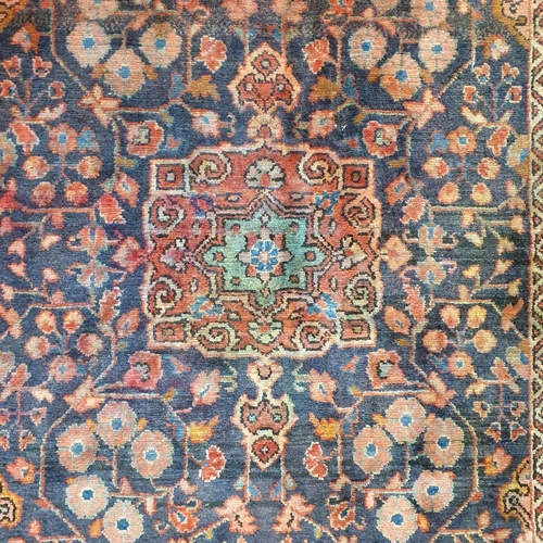 986 - A Persian red ground Carpet with unique central medallion design and multi borders. 207 x 138 approx... 