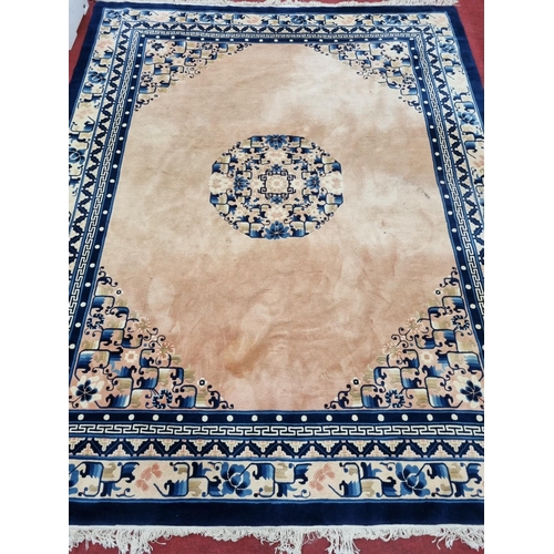 1032 - An Oriental Carpet with Cream ground and Blue border, 325cm x 245cm approx.