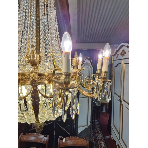 1034 - A Magnificent Crystal and Brass twelve branch Chandelier with basket base. H 124 x D 90 cm approx.