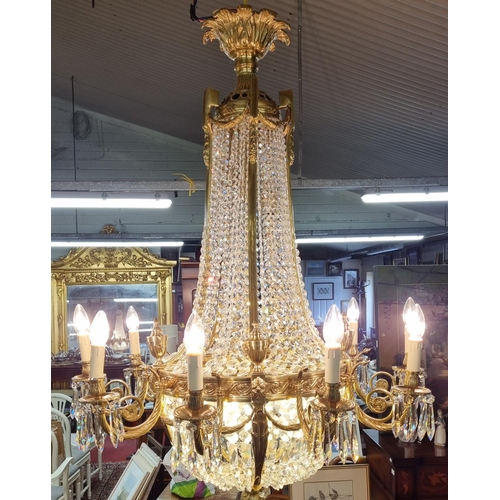 1034 - A Magnificent Crystal and Brass twelve branch Chandelier with basket base. H 124 x D 90 cm approx.