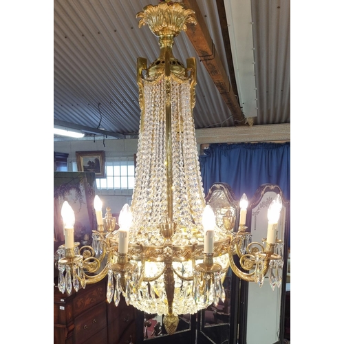 1034 - A Magnificent Crystal and Brass twelve branch Chandelier with basket base. H 124 x D 90 cm approx.