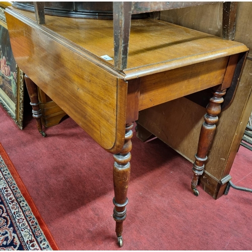 1044A - A 19th Century Mahogany Pembroke Table on turned supports. H 75 x 98 x 106 cm approx.