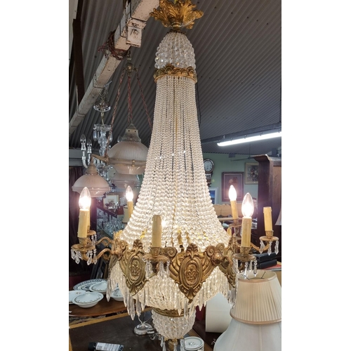 1057 - A Magnificent Crystal and Brass twelve branch Chandelier with basket base. Drop 125 x D 70 cm approx... 