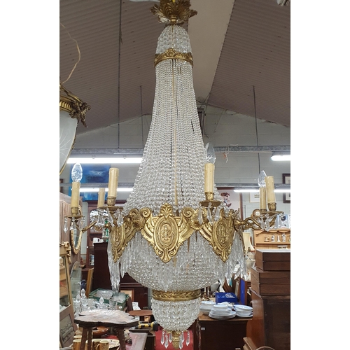 1057 - A Magnificent Crystal and Brass twelve branch Chandelier with basket base. Drop 125 x D 70 cm approx... 