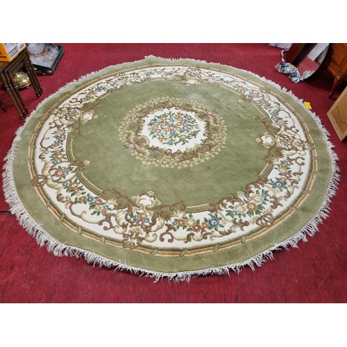 1079 - A very large green ground circular centre Carpet with floral border. D 280 cm approx.