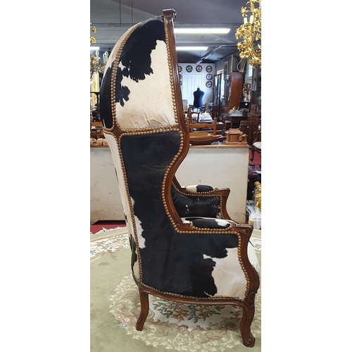 1083 - An unusual and quirky Porters Chair with hide upholstery and heavy deep buttoned outline on carved c... 