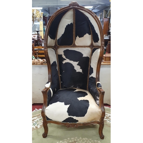 1083 - An unusual and quirky Porters Chair with hide upholstery and heavy deep buttoned outline on carved c... 