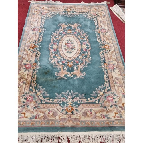 1088 - A green ground Oriental Carpet with floral design 290 x 190 cm approx. .