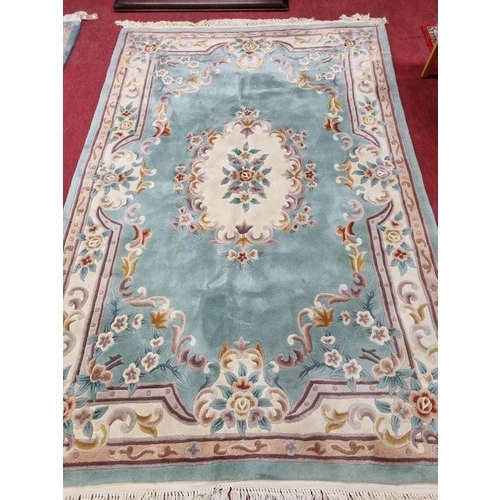 1110 - A good green ground Oriental Carpet with floral outline. 183 x 276 cm approx.