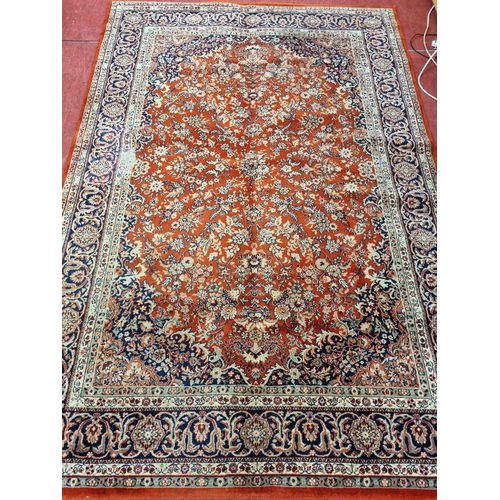 1124 - A large Red ground Carpet with multi borders and medallion design, 290 x 200 cm.