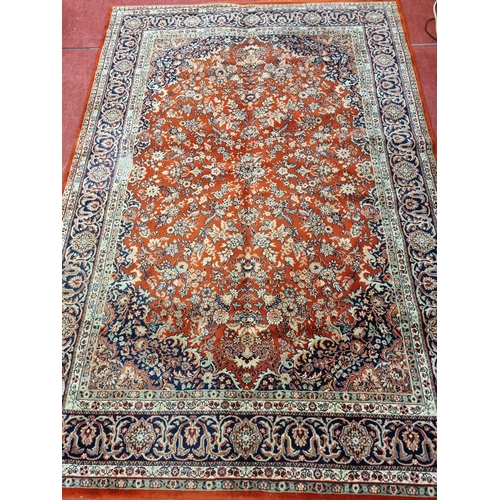 1124 - A large Red ground Carpet with multi borders and medallion design, 290 x 200 cm.