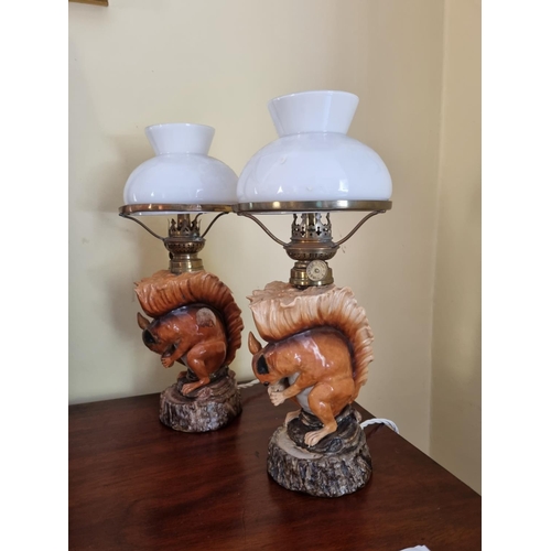 365 - A really good pair of Porcelain Table Lamps depicting squirrels eating nuts.   H 28 cm approx.