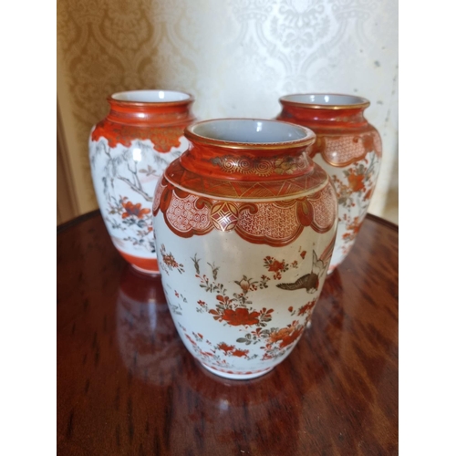 378 - A good set of three cream ground Oriental Vases with hand painted floral decoration and birds of par... 