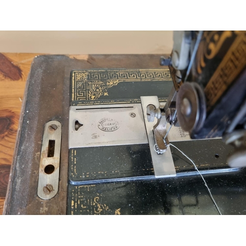 423 - A Vintage Rhodes and Sons sewing Machine in Walnut case.
51 x 28cm approx.