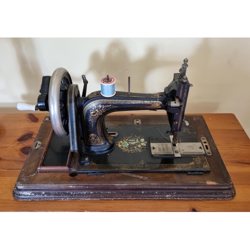 423 - A Vintage Rhodes and Sons sewing Machine in Walnut case.
51 x 28cm approx.