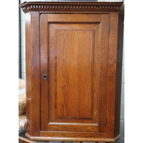 58 - An early 19th Century Oak Corner Unit with dental frieze cornice. H 95 x R 42 cm approx.