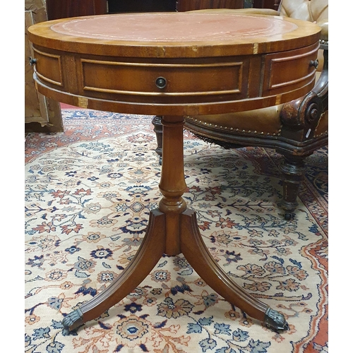 365 - A modern Mahogany circular Drum Table with tooled leather top on tripod supports and castors. (some ... 