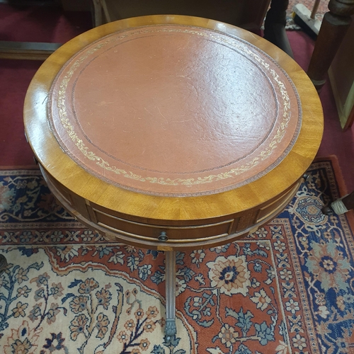 365 - A modern Mahogany circular Drum Table with tooled leather top on tripod supports and castors. (some ... 