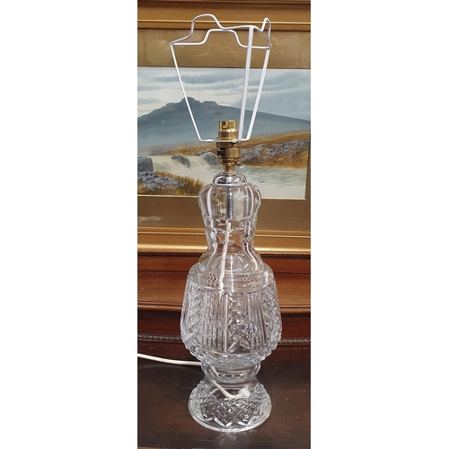 367 - A Brass and Glass effect Table Lamp with shade along with a crystal example. H 58 cm approx.