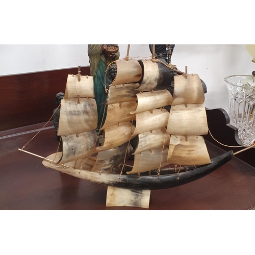 388 - A quantity of African and Asian Figures along with a bone scratch built sailing Ship in full mask.
T... 