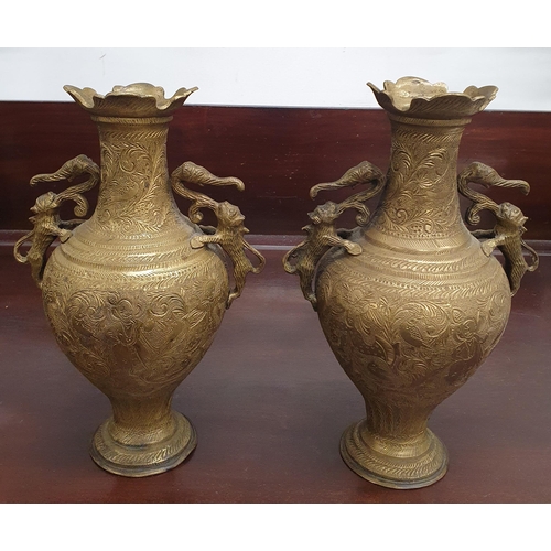 391 - A pair of early Brass Oriental/ Asian Vases with handles. H 26 cm approx.