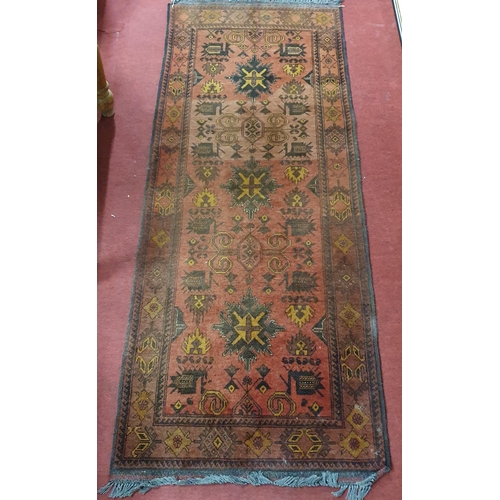 438 - A good Persian Red ground Runner with unique central medallion design and multi borders.
L 215 x W 8... 