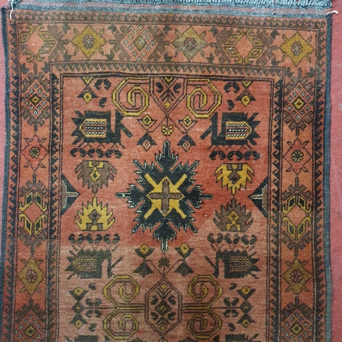 438 - A good Persian Red ground Runner with unique central medallion design and multi borders.
L 215 x W 8... 