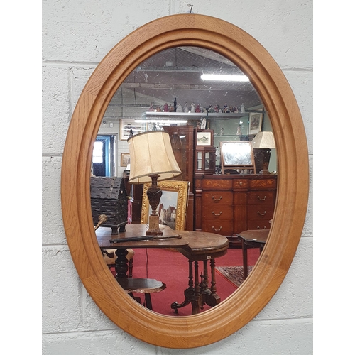 511 - An oak Oval Mirror .
H 85 x W 64 cm approx.