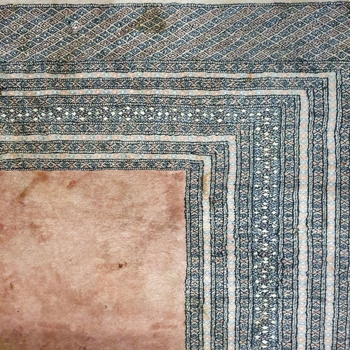 356 - A large pink ground Rug with pink central panel and multi borders. L 300 x W 220 x cm approx.