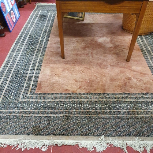 356 - A large pink ground Rug with pink central panel and multi borders. L 300 x W 220 x cm approx.