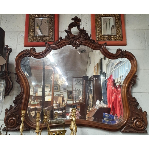 A good 19th Century Mahogany show framed Mirror with cartouche carved top and bevelled glass. W 130 x 106 cm approx.