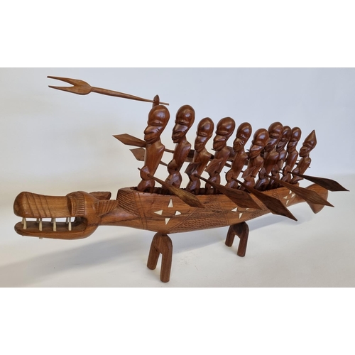 963 - A large Hardwood Polynesian style Boat with men and  bone inlay. L 93 cm approx.