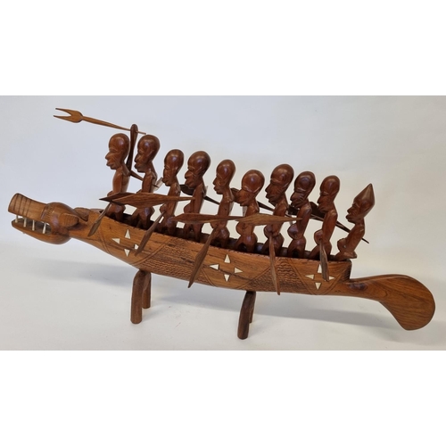 963 - A large Hardwood Polynesian style Boat with men and  bone inlay. L 93 cm approx.