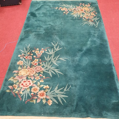 398 - Oriental Style Turquoise Green Rug with Floral Design in 2 Corners .
L 243 x W 136 cm approx.