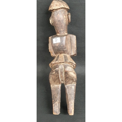 42A - A carved African tribal Figure of a man standing. H 40 cm approx.