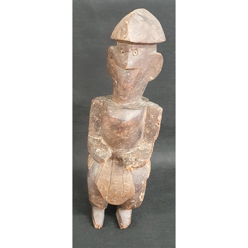 42A - A carved African tribal Figure of a man standing. H 40 cm approx.