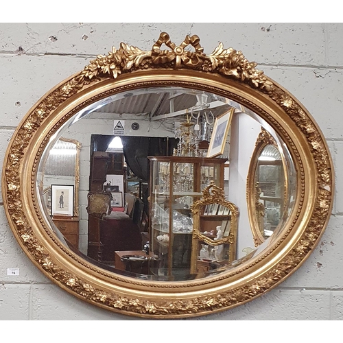 76 - A good Timber and Plaster Gilt oval Mirror with highly carved cartouche top and bevelled mirror glas... 