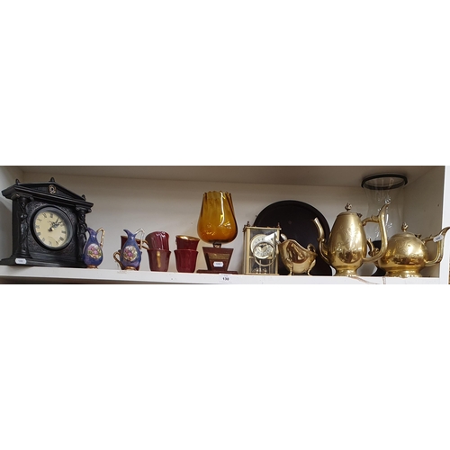 130 - A good quantity of Items on one shelf to include brass and a mantel clock.