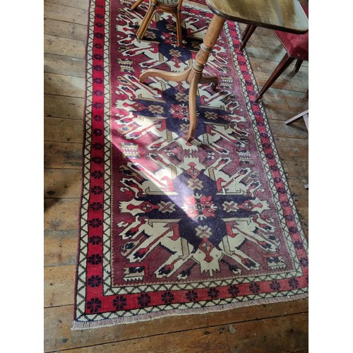 150 - A handwoven Turkish Kars Kazakh Rug with a sunburst design. 234 x 117cm approx.