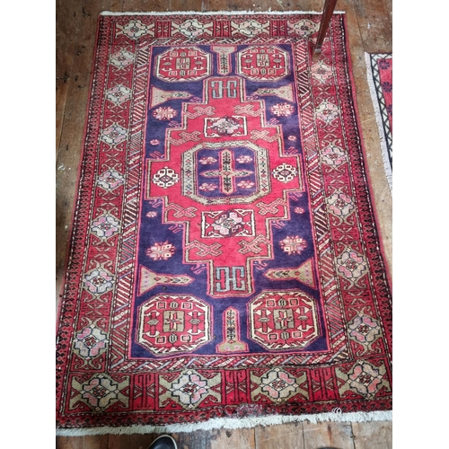 155 - A Persian Red ground Rug with unique medallion design. 175 x 114 cm approx.