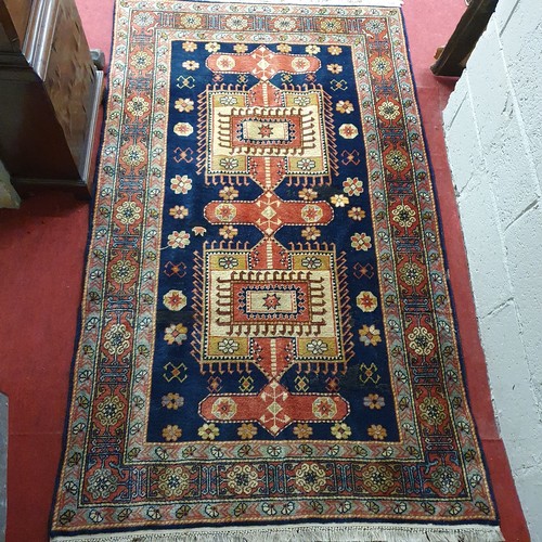 200 - A Blue ground Persian Rug with a unique medallion design. 202 x 199cm approx.