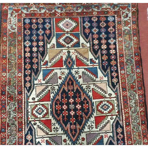 201 - A Red and Blue ground Persian rug with lozenge medallion design.
W 133 x L 133 cm approx.