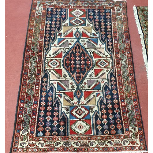 201 - A Red and Blue ground Persian rug with lozenge medallion design.
W 133 x L 133 cm approx.