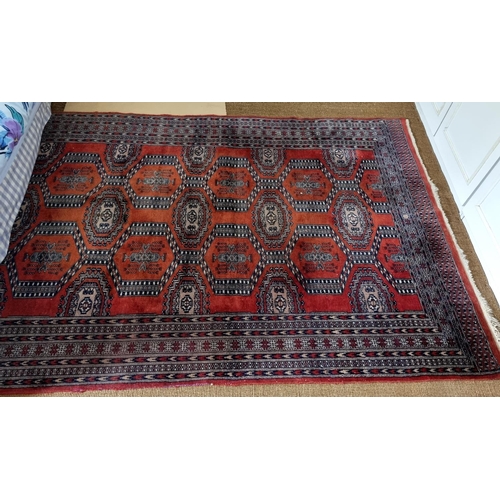 202 - A good red ground Rug with repeating central medallion design and multi borders. 253 x 155cm approx.