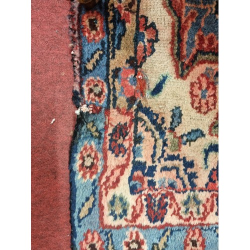 208 - A Red ground Persain Rug with a unique medallion design and multi borders. 243 x 162cm approx.